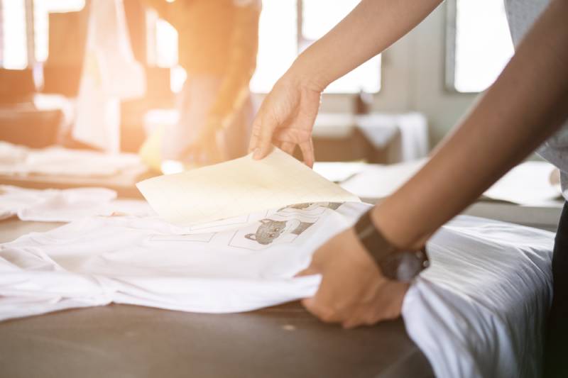 person printing on t-shirt