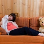 A pregnant woman and a cat.