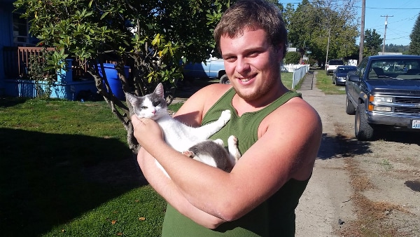 A relieved cat guardian hugging his rescued cat.