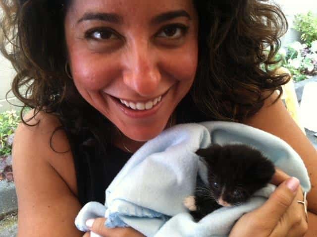 Cooper holds Nelson, a bottle-fed kitten, at Meow Cat Rescue in Washington state.