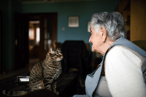 An elderly woman with her cat. 