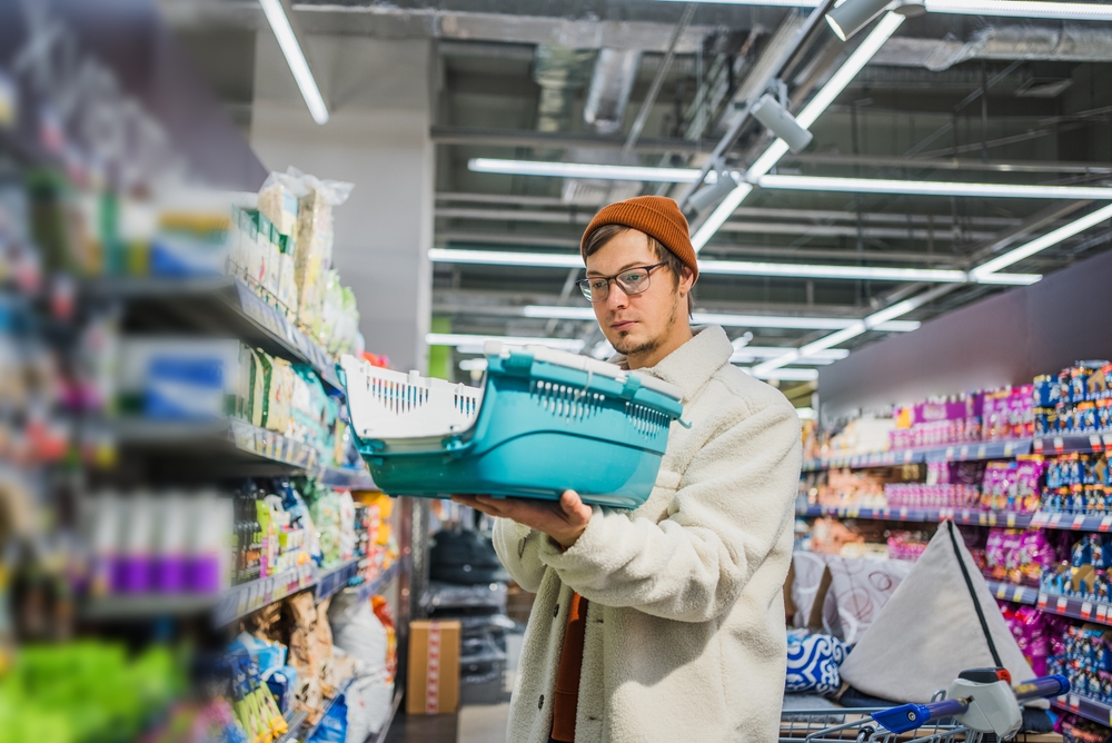 Cat owner in a store choosing a litter box