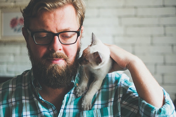 A cat guy with a cat on his shoulder.