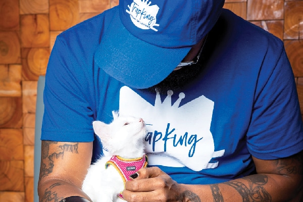 Trapking with a cat looking up.