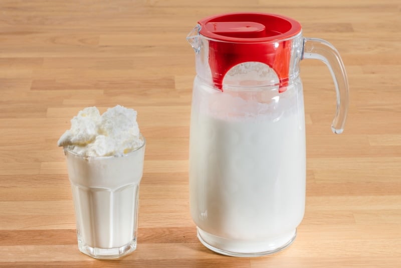 Buttermilk in a pitcher and glass on the table