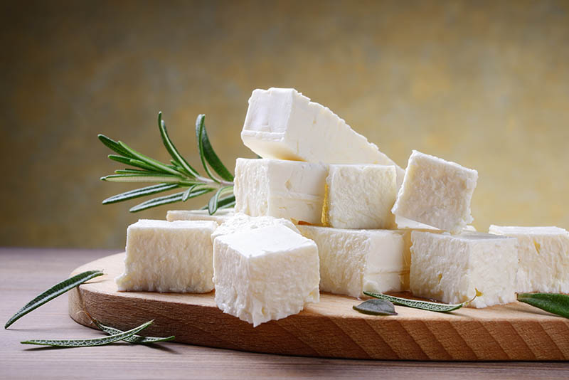 Feta cheese with rosemary on rustic background