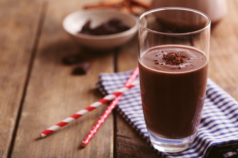 Glass of chocolate milk on table