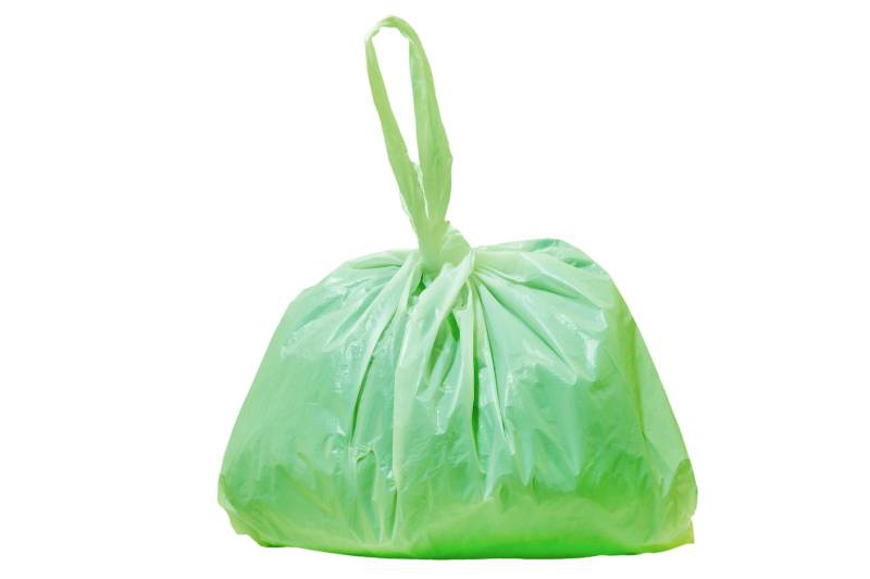 Green plastic bag isolated on white background