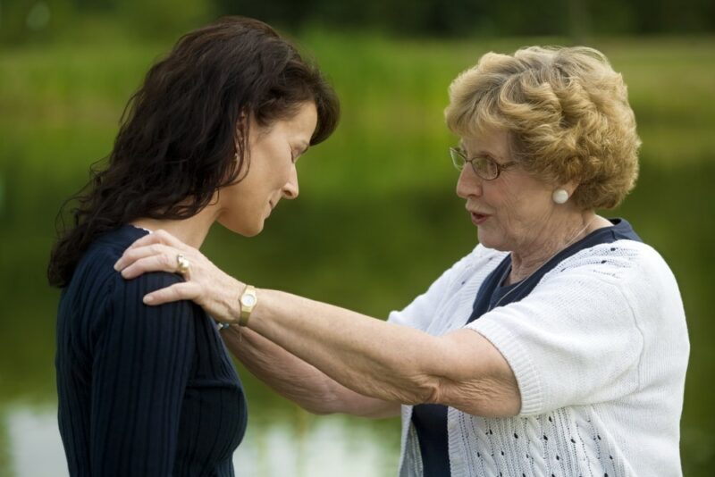 Old Lady talking to a sad woman