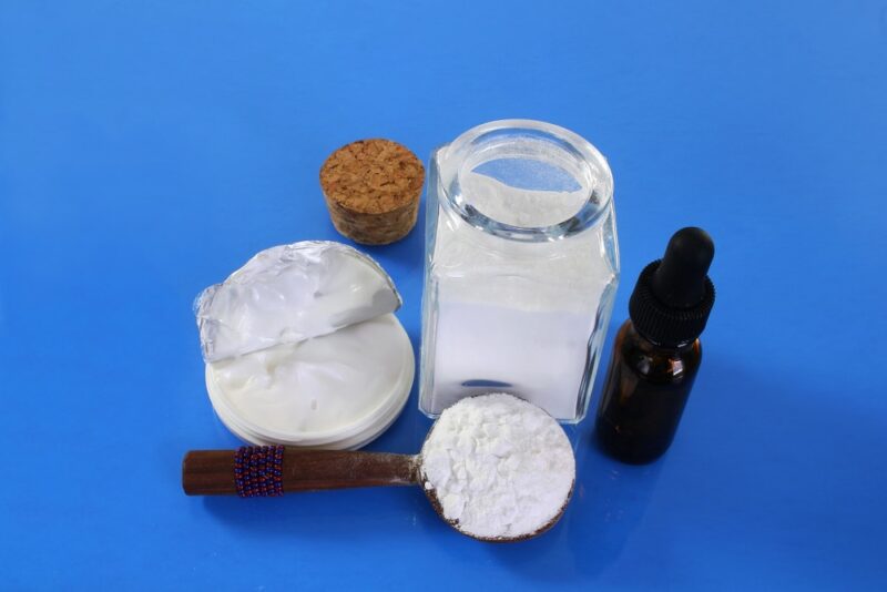 boric acid powder in spoon with boric cream and drops bottle