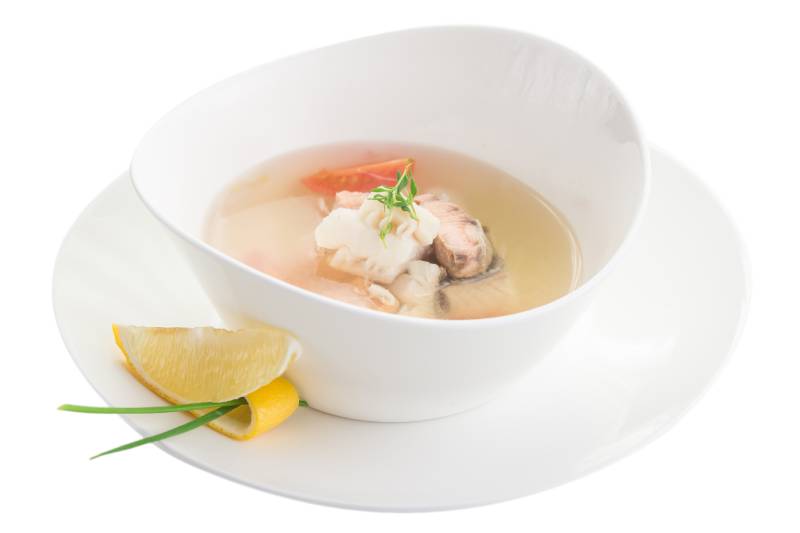 bowl of fish soup isolated on white background