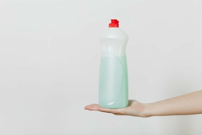 dishwashing detergent dispenser on a womans hand