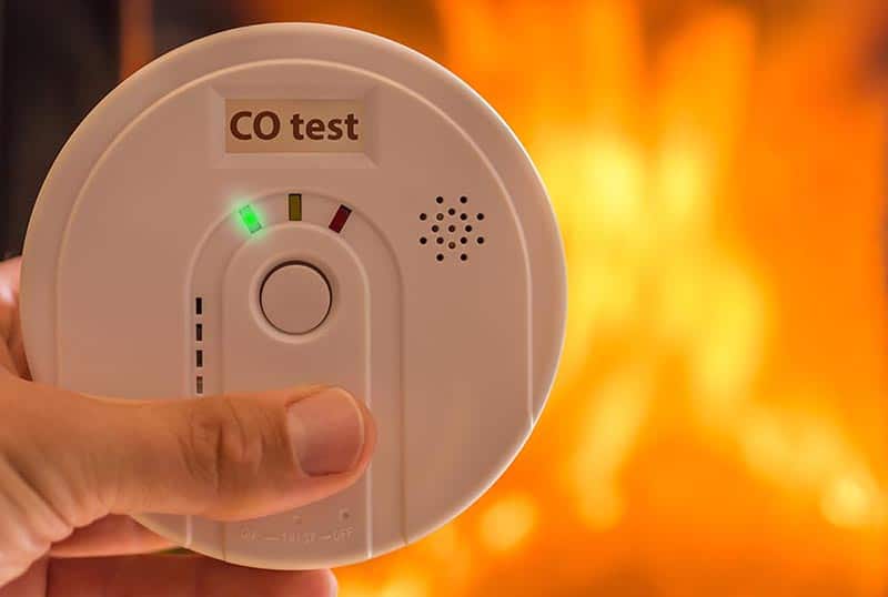 hand holding carbon monoxide alarm