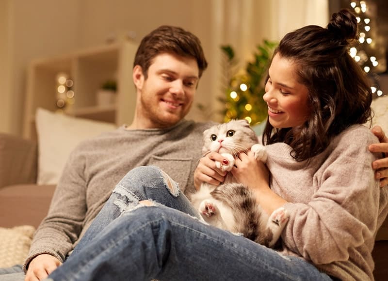 happy couple with cat at home