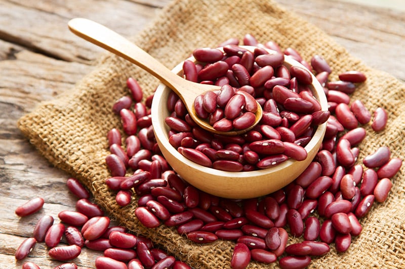 kidney beans on a wooden bowl with spoon