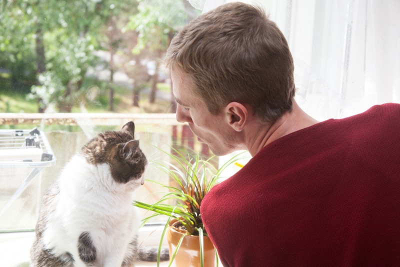 man talking to her cat