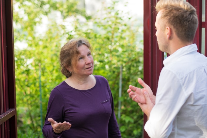 neighbors talking by the gate