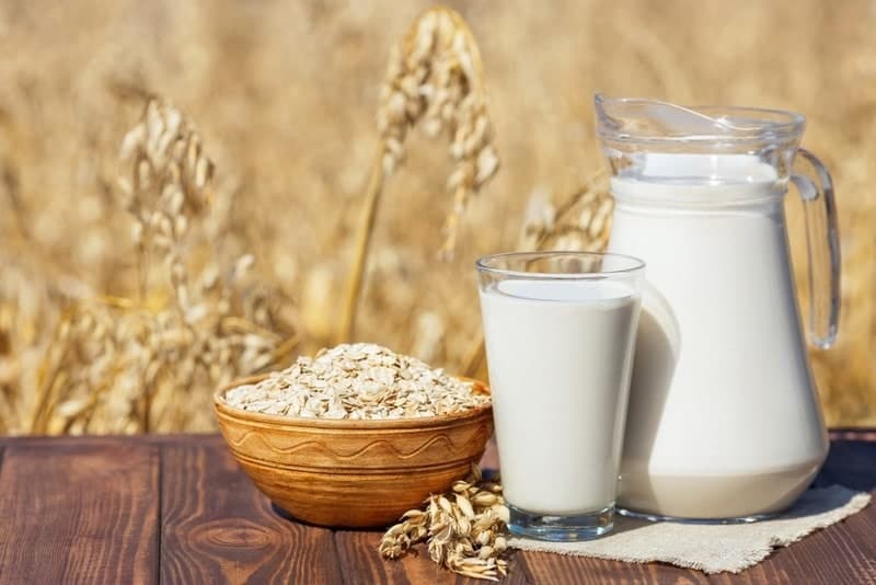 oat milk in a glass and pitcher