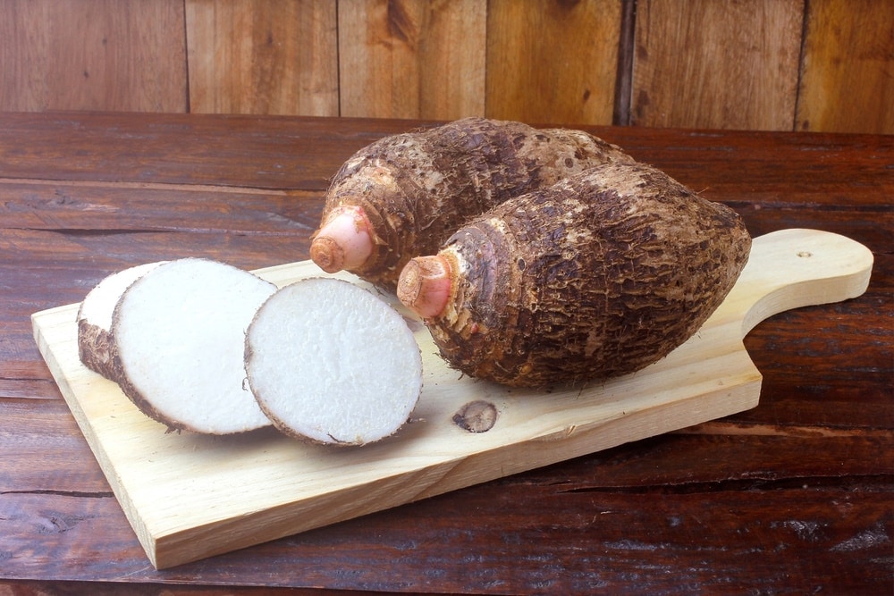 raw yams on wooden table