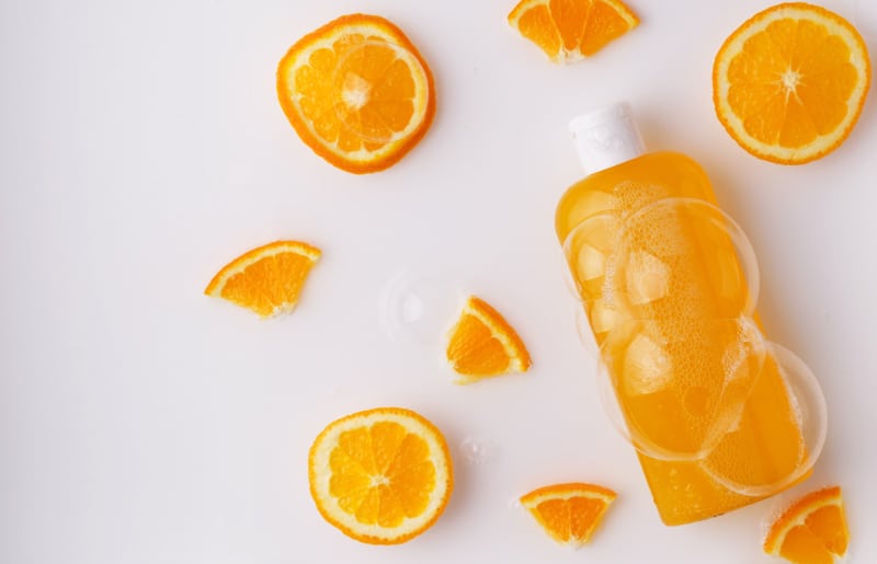shampoo bottle with bubbles and orange slices