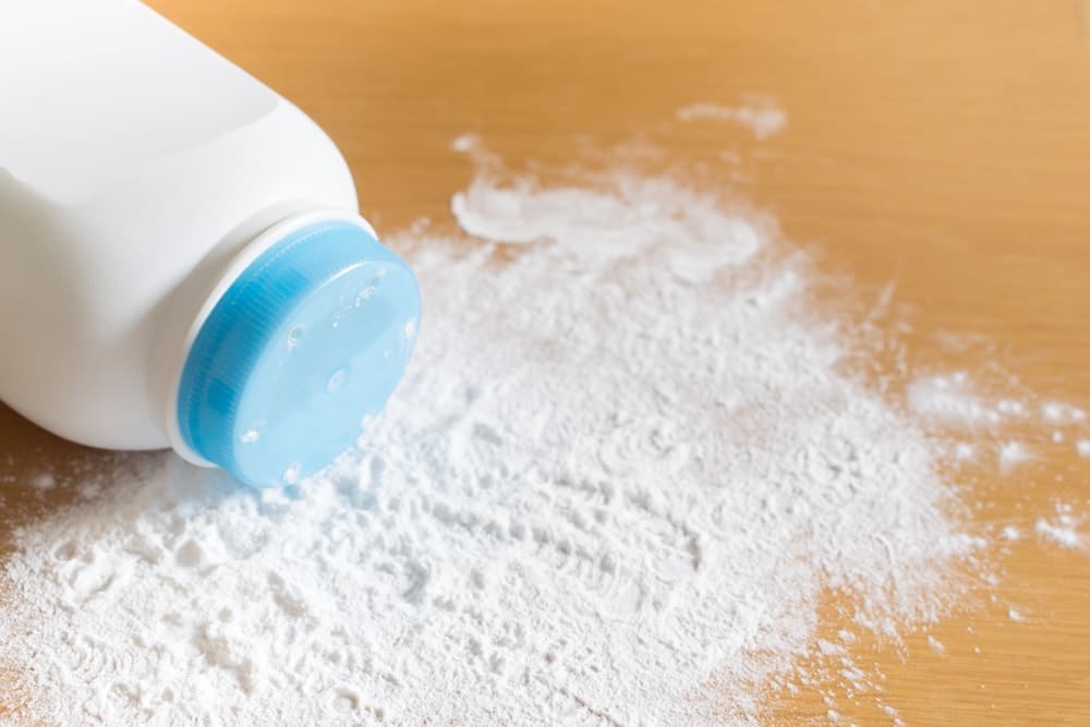 Baby talcum powder container on wooden background