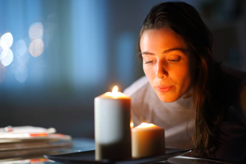 woman blowing out candles