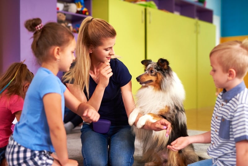 woman introducing dog to kids