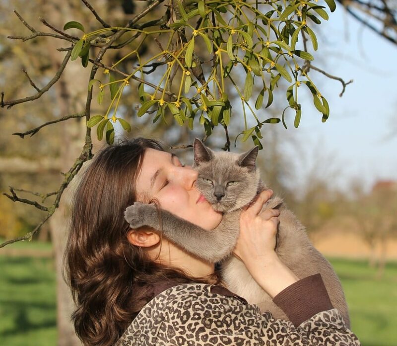 woman kissing her cat