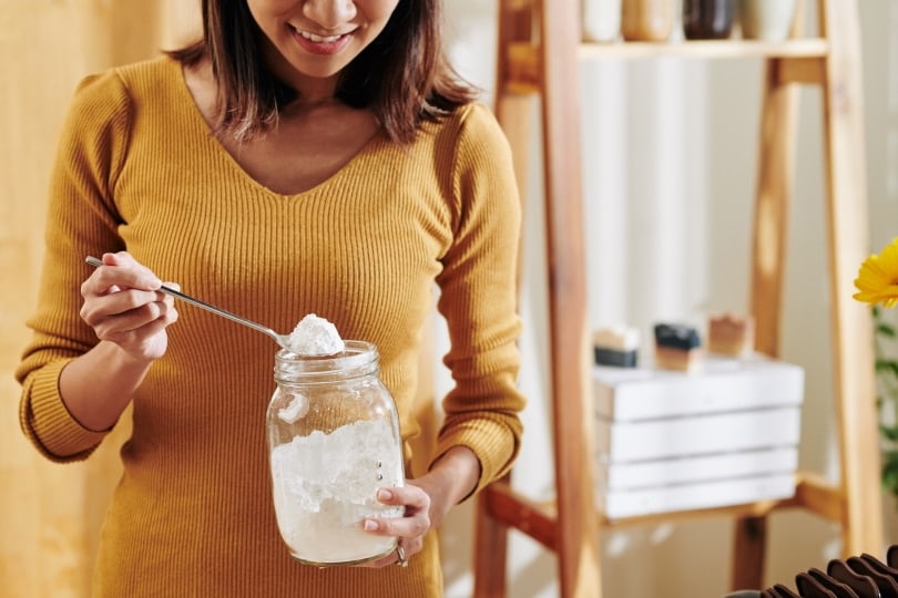 woman with jar of baking soda
