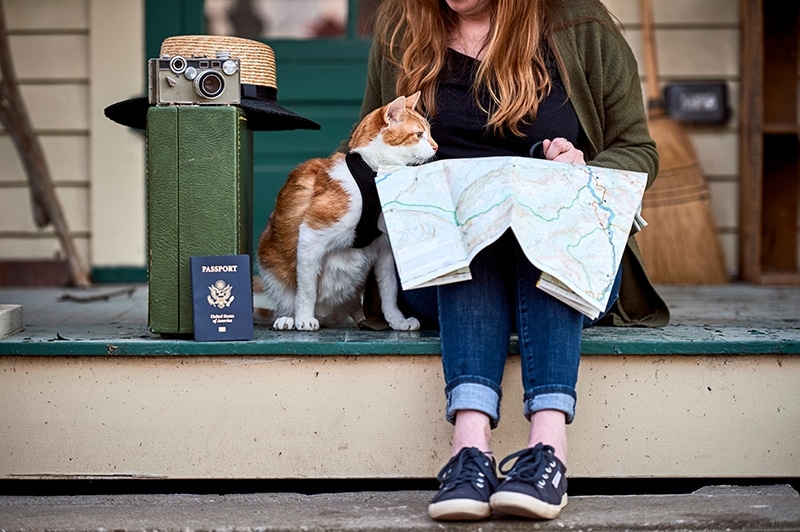 young woman and cat travelling with US passport