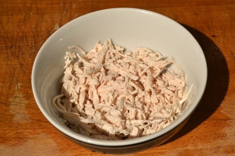 Boiled chicken strips drained