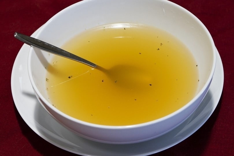 Chicken broth soup in a bowl