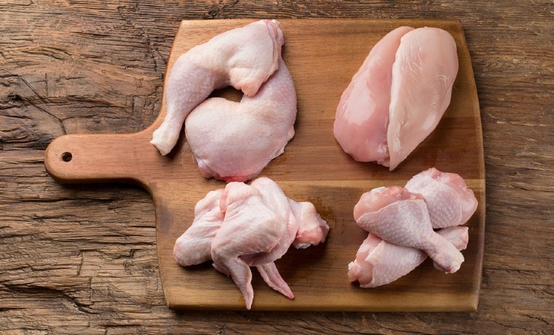 Raw chicken meat on wooden board