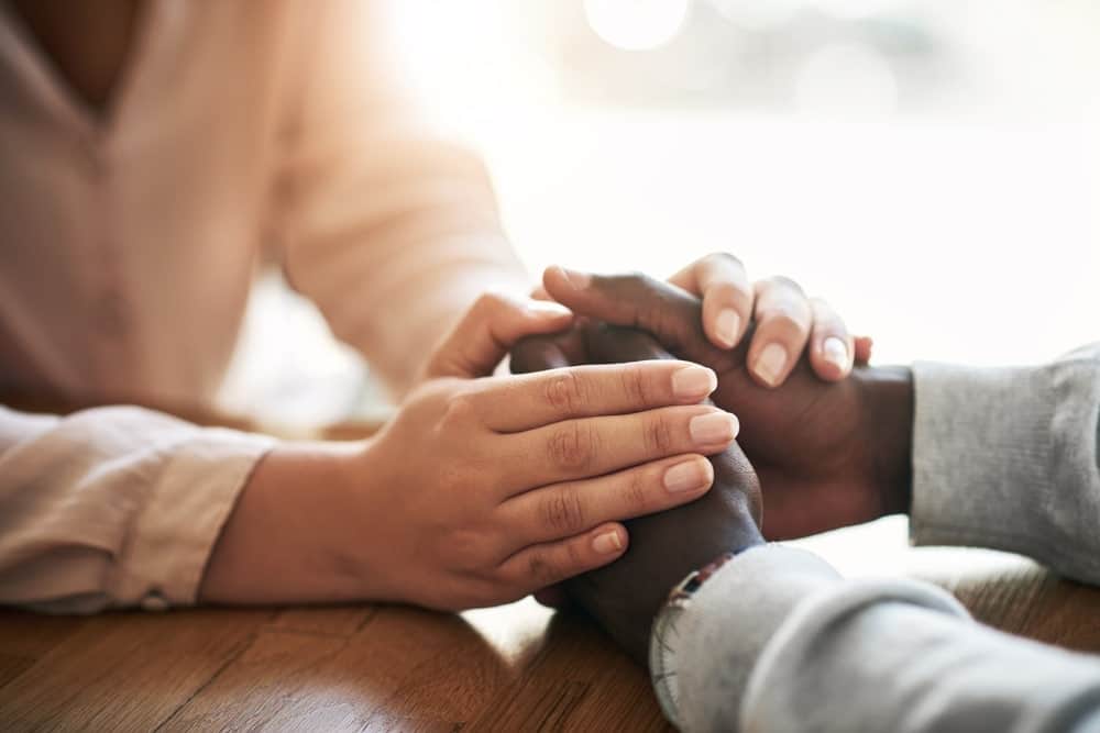 Two people holding hands