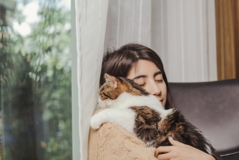 Woman-owner-hugging-cat