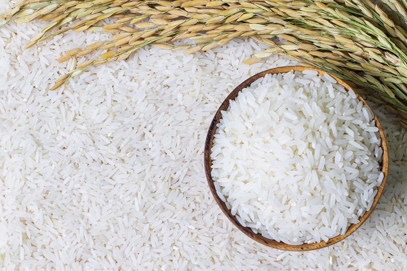 Wooden bowl with rice on rice and rice