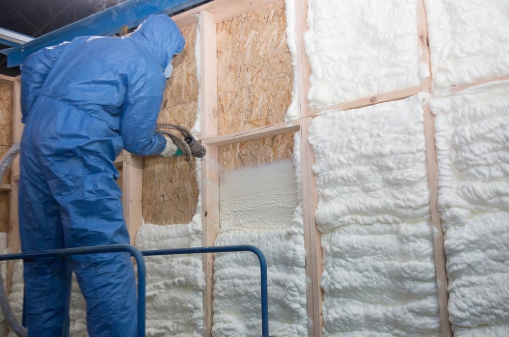 Worker insulates house