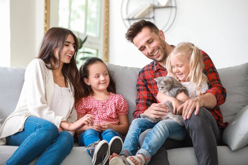 a happy family with their pet cat