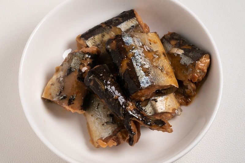 boiled sardines on a white plate