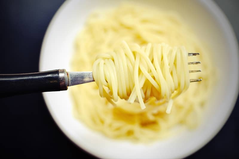 cooked plain pasta curled in the fork
