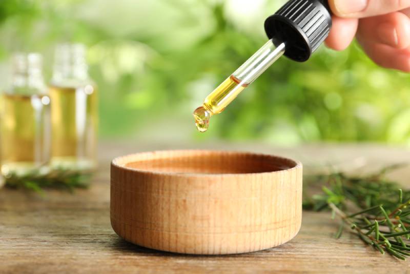 dripping natural tea tree oil in bowl