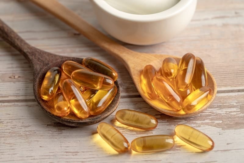 fish oil capsules in wooden table