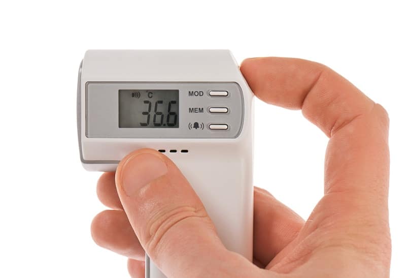 hand holding digital thermometer