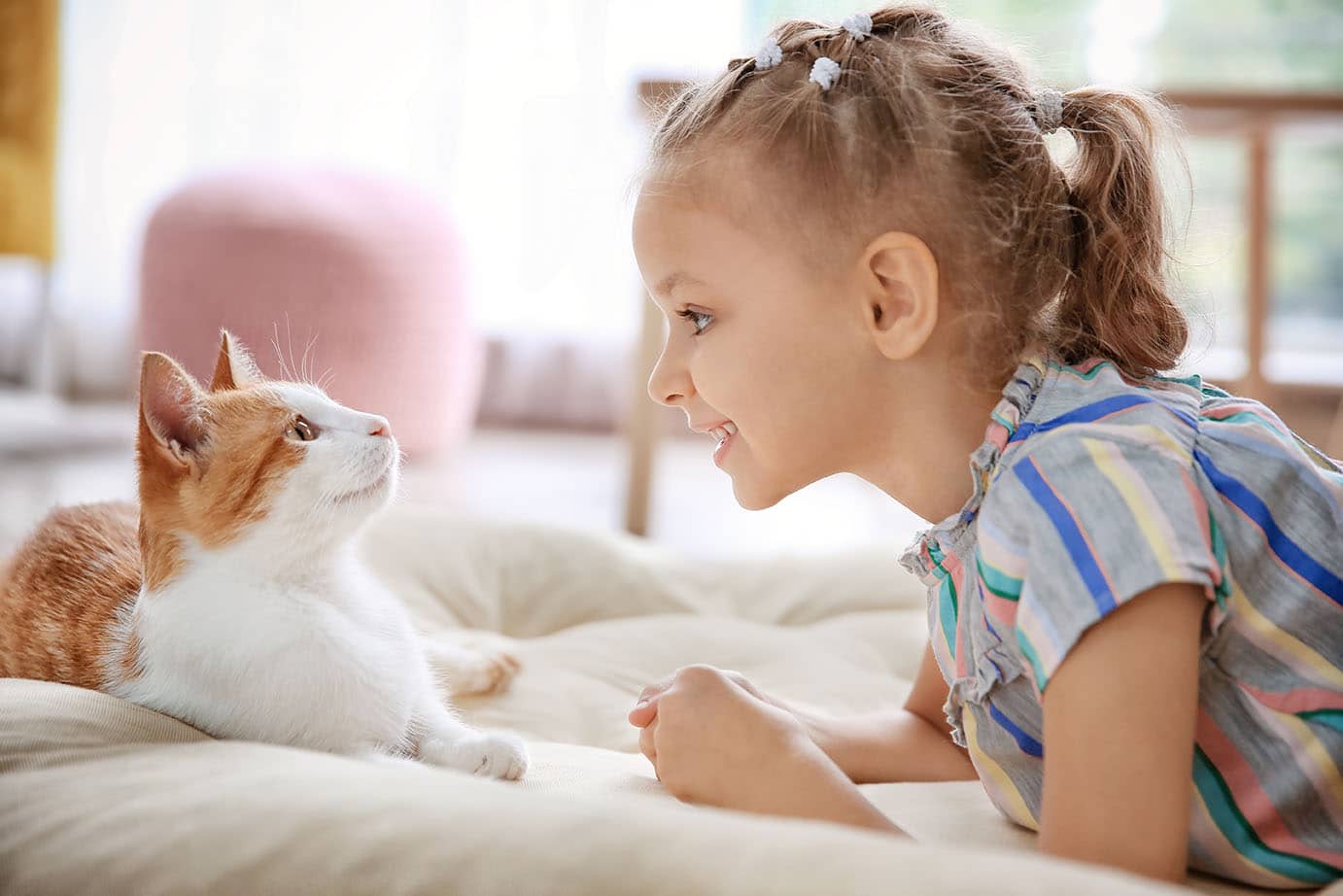 little girl talking to cat