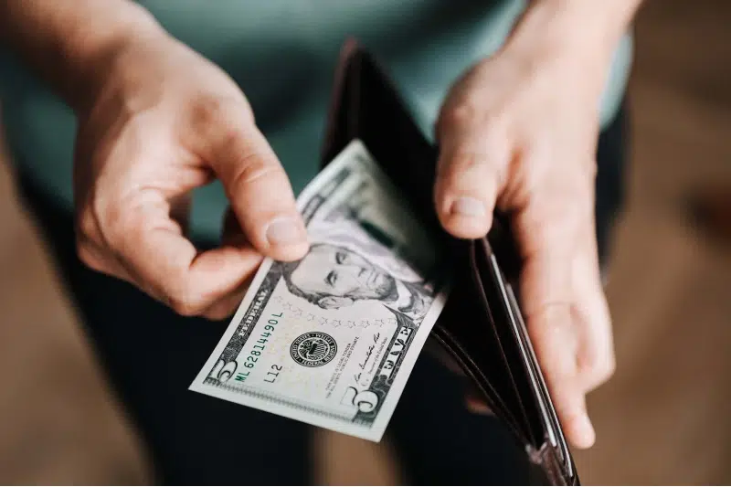 man pulling out money out of wallet