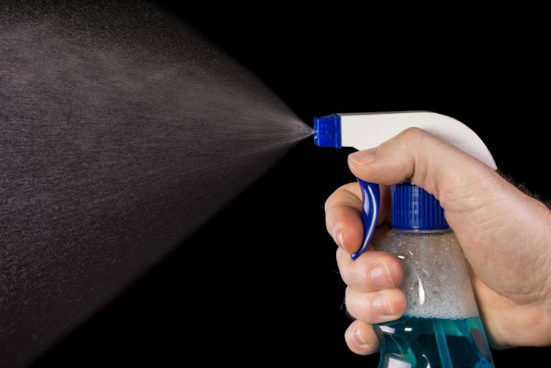 man spraying using bottle spray