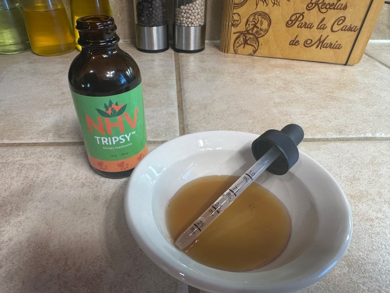 nhv tripsy supplement in a bowl with dropper