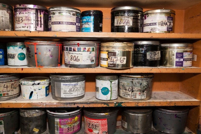 old paint cans in shelves