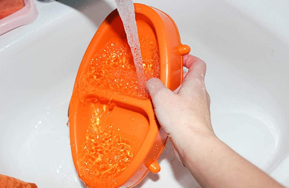 rinsing orange pet food bowl