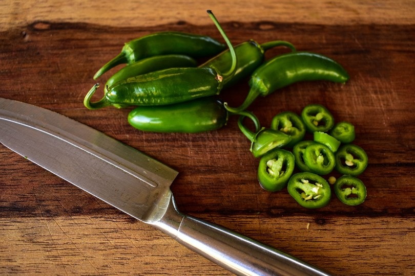 sliced jalapenos on chopping board